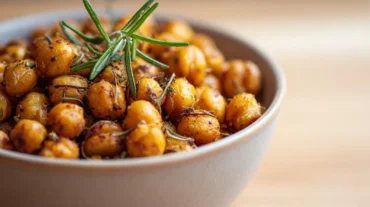 Leckere geröstete Kichererbsen mit Rosmarin aus dem Airfryer, perfekt als Snack.